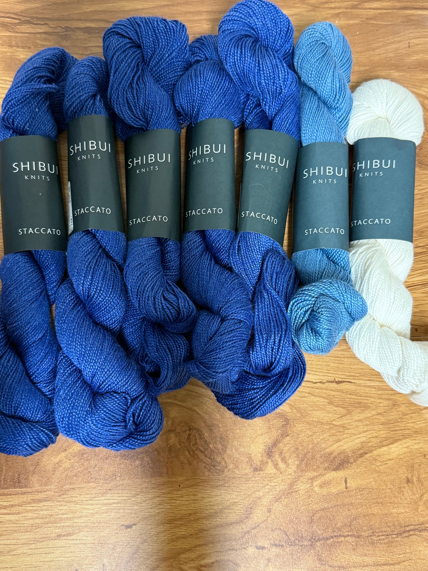 DESTASH: 7 skeins of Shibui Knits Staccato in colorway Blueprint (5x royal blue), Shore (1x light blue), and White (1x)